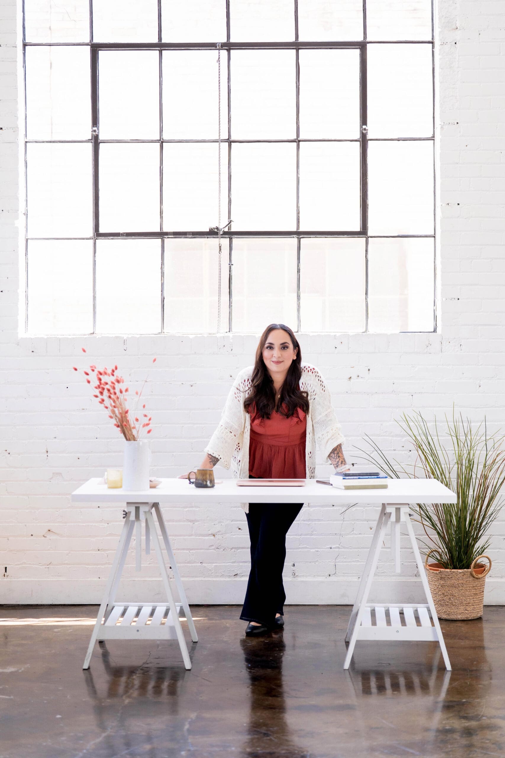 Steph standing behind her desk