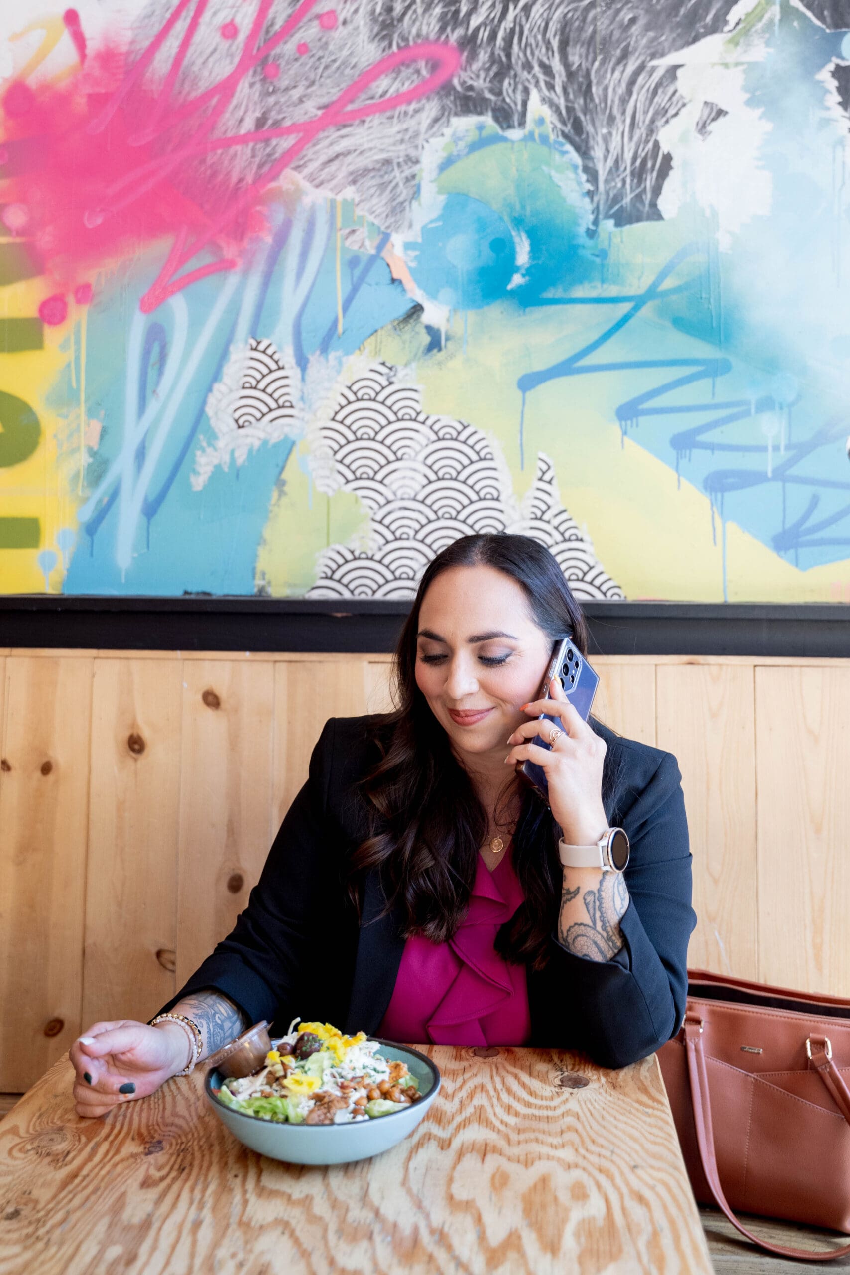 Steph on her phone at a coffee shop